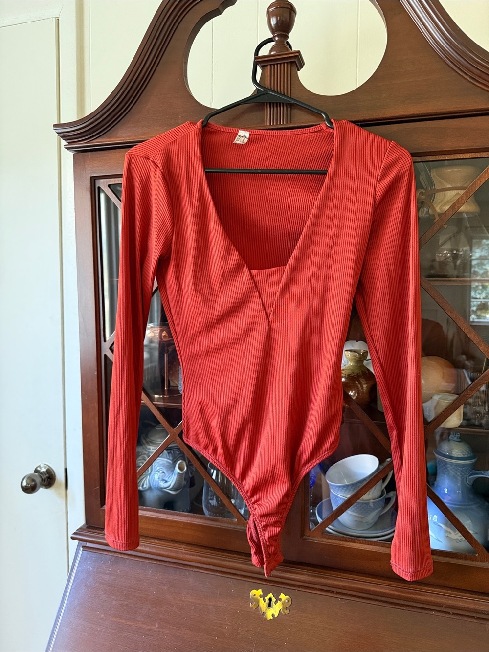 Free People Ribbed Long Sleeve Bodysuit in Rust Red
